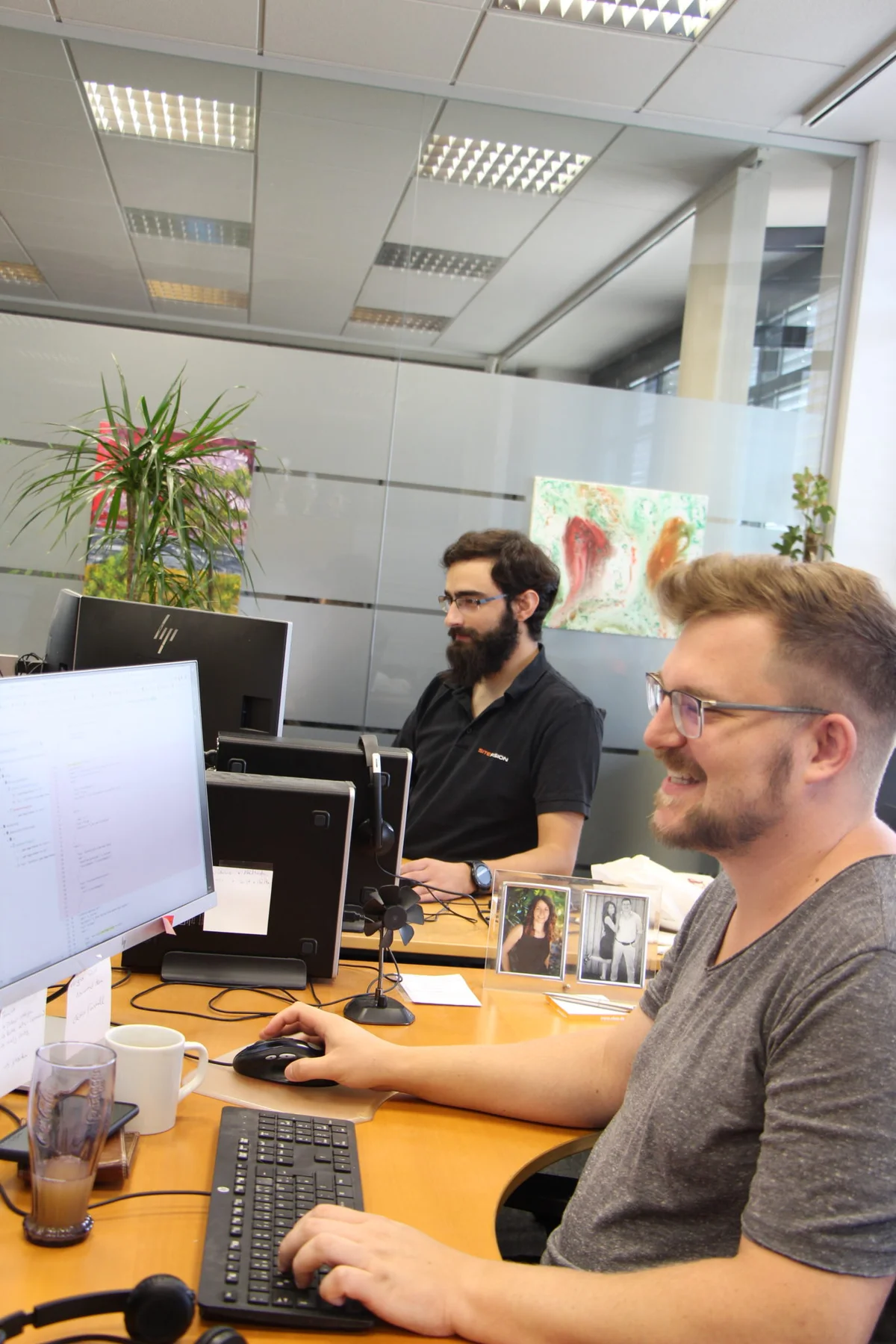 Colleagues at their desks in the SiteFusion office